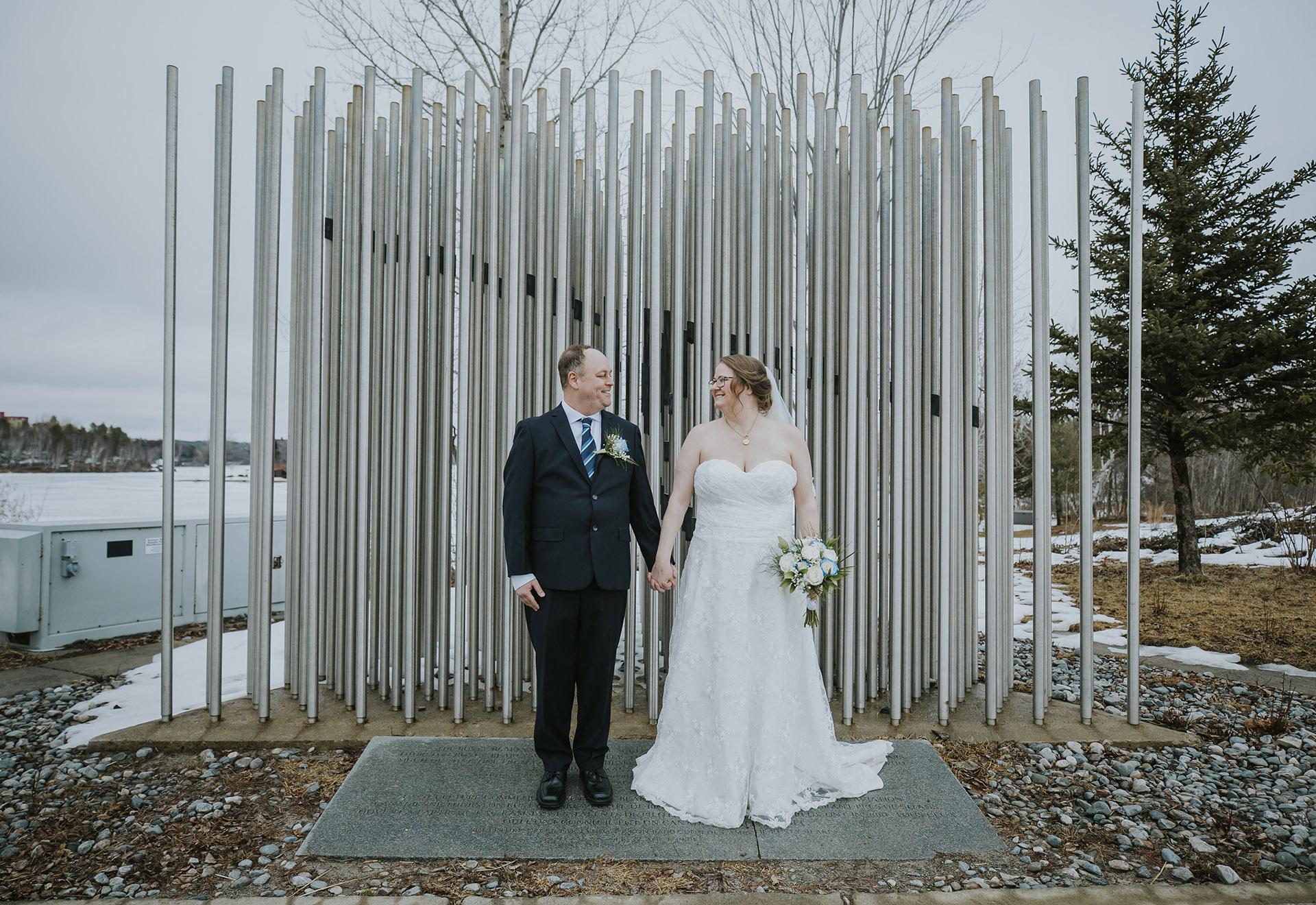 Bride and groom looking at each other in Ramsay lake in Sudbury