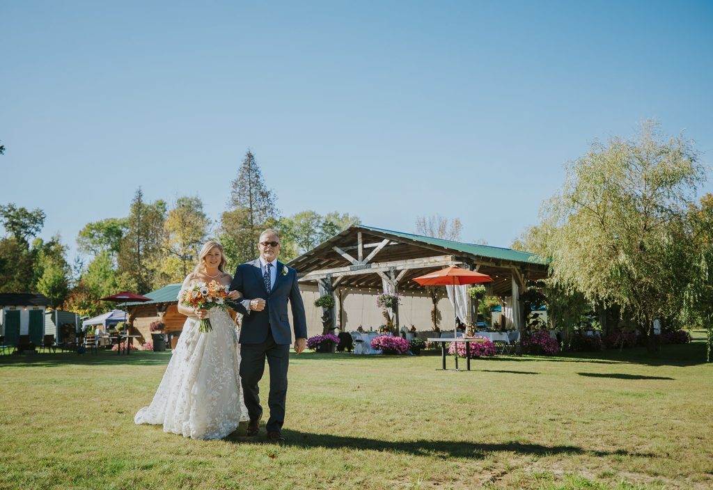 Bride walking with her dad to the ceremony during an intimate wedding in Sudbury, Ontario captured by a Sudbury Ontario wedding photographer