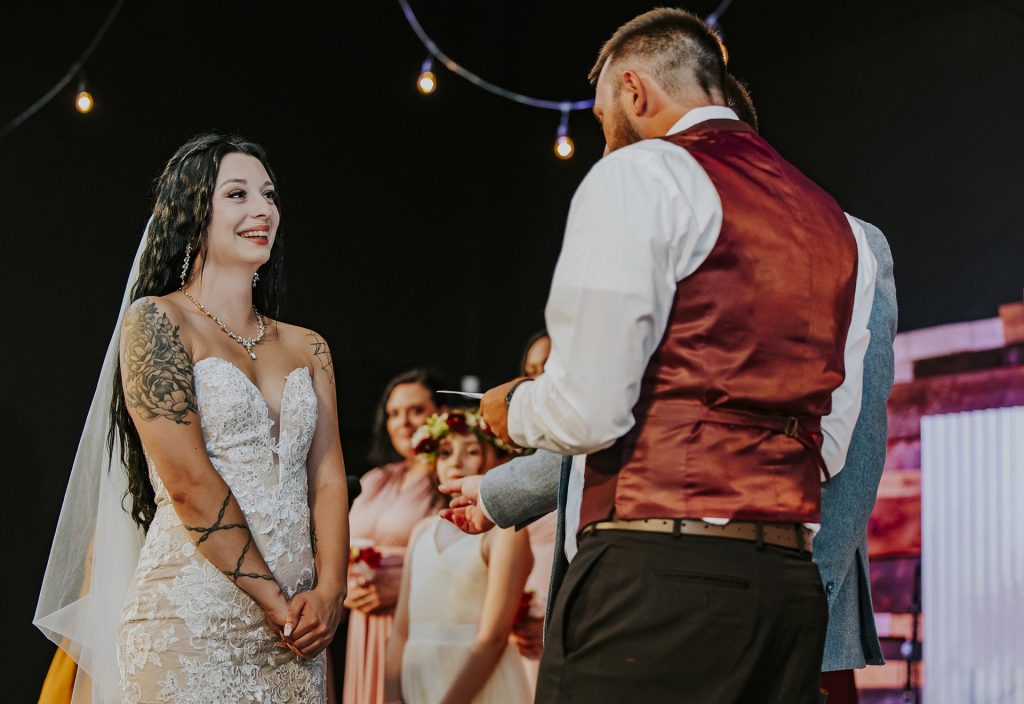 Groom reading the vows during the ceremony to the astonished bride during an intimate wedding in Sudbury, Ontario captured by a Sudbury Ontario wedding photographer