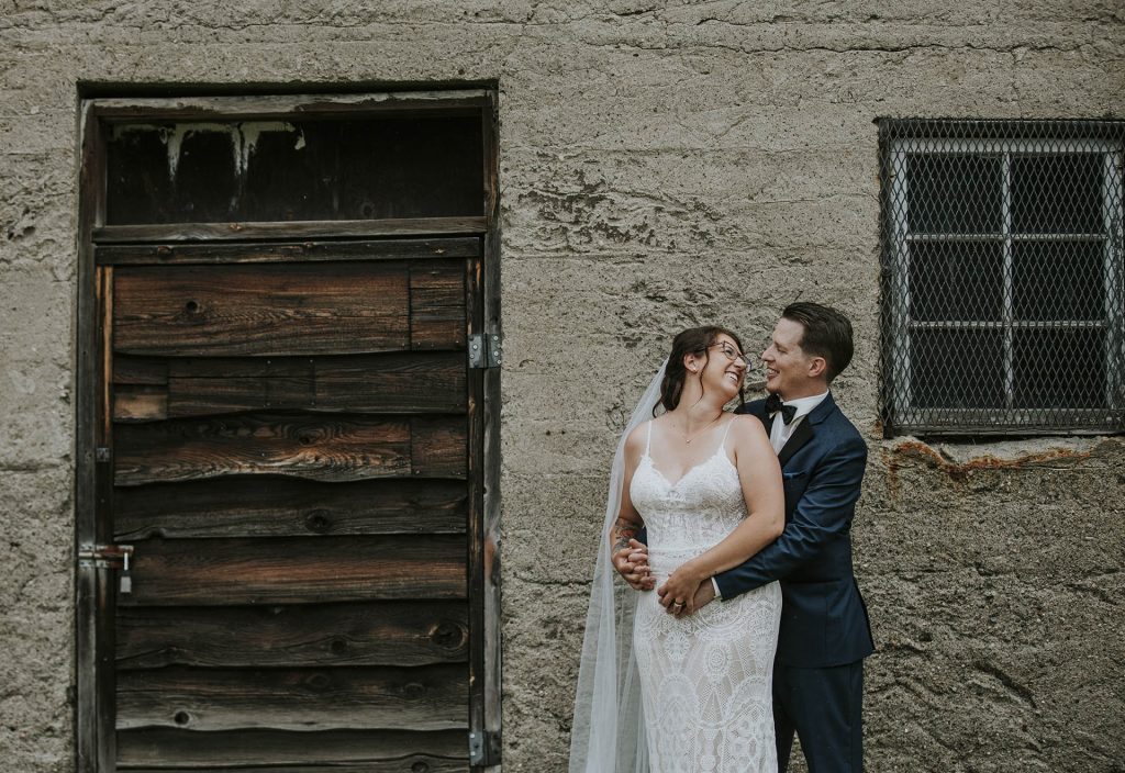 Bride and groom smiling during their wedding portraits in Sudbury, Ontario captured by a Sudbury Ontario wedding photographer