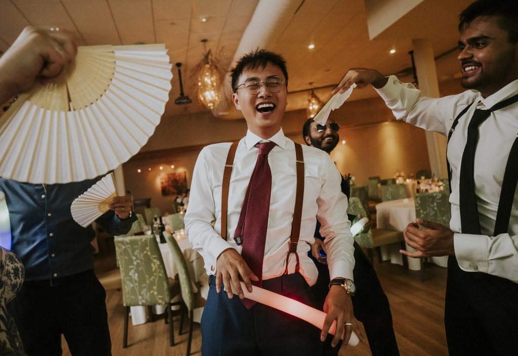 Groom having fun with friends during the wedding party in Sudbury, Ontario captured by a Sudbury Ontario wedding photographer