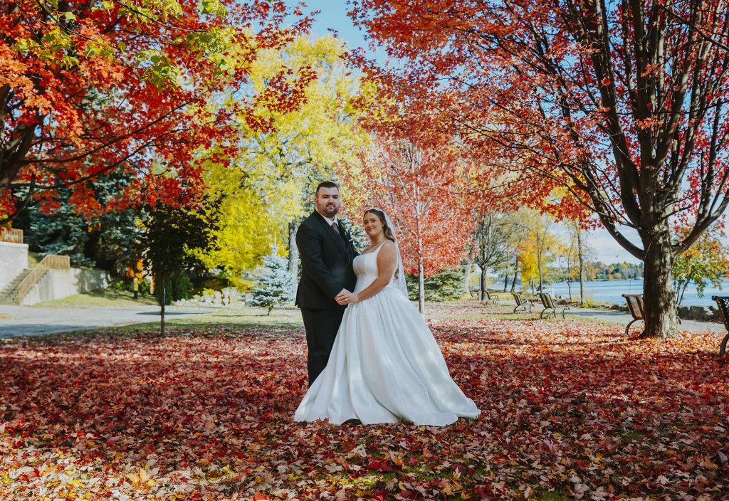 Couple portraits in the fall with yellow and red trees in Sudbury, Ontario